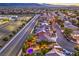 Stunning aerial view of a neighborhood showcasing a home with a pool, lush landscaping, and outdoor entertaining areas at 9805 Turtle Walk Ave, Las Vegas, NV 89149