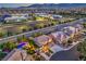 Expansive aerial shot of a neighborhood featuring homes with pools and well-maintained landscaping at dusk at 9805 Turtle Walk Ave, Las Vegas, NV 89149