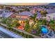 Aerial view of backyard with a pool, pergola, putting green and a lushly landscaped yard at 9805 Turtle Walk Ave, Las Vegas, NV 89149