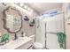 Clean bathroom with a glass-enclosed shower, a vanity, and decorative accents at 9805 Turtle Walk Ave, Las Vegas, NV 89149