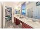 Bright bathroom featuring double vanity sinks, updated fixtures, and archway leading to bedroom at 9805 Turtle Walk Ave, Las Vegas, NV 89149