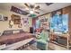 Lively bedroom featuring window views, guitars, flags, and an armchair at 9805 Turtle Walk Ave, Las Vegas, NV 89149