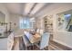 Cozy dining room with wood floors, decorative light fixture, plantation shutters, and a decorative sideboard at 9805 Turtle Walk Ave, Las Vegas, NV 89149