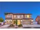 Two-story home featuring stone accents, a tile roof and a three-car garage at 9805 Turtle Walk Ave, Las Vegas, NV 89149