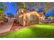 Charming home exterior with a well-manicured lawn, complemented by a stone patio and inviting outdoor seating at 9805 Turtle Walk Ave, Las Vegas, NV 89149