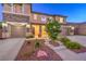 Two-story home featuring stone accents, a tile roof and a three-car garage at 9805 Turtle Walk Ave, Las Vegas, NV 89149