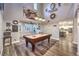Spacious game room with a high ceiling, a pool table, and a view of the kitchen at 9805 Turtle Walk Ave, Las Vegas, NV 89149