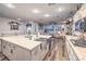 Bright kitchen featuring a large island with granite countertops, stainless steel sink, and a gas stove cooktop at 9805 Turtle Walk Ave, Las Vegas, NV 89149