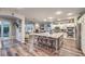 Open floor plan kitchen with a large island, counter seating, stainless steel appliances, and access to the living room at 9805 Turtle Walk Ave, Las Vegas, NV 89149