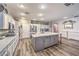 Spacious kitchen features a large island with white cabinets, granite countertops and modern stainless steel appliances at 9805 Turtle Walk Ave, Las Vegas, NV 89149