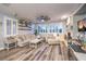 Cozy living room features a comfortable sofa, stone fireplace, plantation shutters, and hardwood floors at 9805 Turtle Walk Ave, Las Vegas, NV 89149