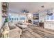 Bright and open living room features a stone fireplace, decorative shelves and plantation shutters at 9805 Turtle Walk Ave, Las Vegas, NV 89149