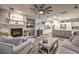 Cozy living room with a stone fireplace and an open floor plan flowing into the kitchen at 9805 Turtle Walk Ave, Las Vegas, NV 89149
