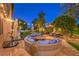 Beautiful outdoor patio featuring a fire pit and comfortable circular seating area, perfect for entertaining guests at 9805 Turtle Walk Ave, Las Vegas, NV 89149