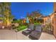 Relaxing patio with lounge chairs, surrounded by lush landscaping, perfect for enjoying the outdoors at 9805 Turtle Walk Ave, Las Vegas, NV 89149