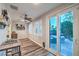Bright sunroom with access to a brick patio and outdoor seating area at 9805 Turtle Walk Ave, Las Vegas, NV 89149