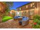 Spacious patio with comfortable seating around a fire pit, ideal for relaxation and outdoor gatherings at 9805 Turtle Walk Ave, Las Vegas, NV 89149