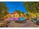 Lush backyard featuring a pool, rock features, and outdoor bar area at 9805 Turtle Walk Ave, Las Vegas, NV 89149