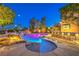 Backyard pool with unique rock waterfall feature and outdoor bar seating at 9805 Turtle Walk Ave, Las Vegas, NV 89149