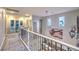 Upstairs hallway with wrought iron railings, art decorations, and natural lighting at 9805 Turtle Walk Ave, Las Vegas, NV 89149