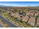 A high-angle aerial view of a residential area with various homes, landscaping, and community features at , Las Vegas, NV 89138