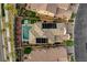 An aerial view of a property with a swimming pool, hot tub, and manicured landscaping surrounded by neighboring homes at , Las Vegas, NV 89138