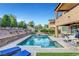Spacious backyard with a large pool, mature landscaping, and a covered patio at , Las Vegas, NV 89138