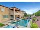 Expansive outdoor area with a pristine pool, hot tub, patio furniture, and built in outdoor entertainment space at , Las Vegas, NV 89138
