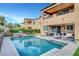 A backyard featuring a pool, spa, patio seating, and lush landscaping, ideal for outdoor living and entertaining at , Las Vegas, NV 89138