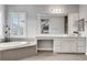 Luxurious bathroom featuring double vanities, a soaking tub, and plantation shutters, offering a spa-like experience at , Las Vegas, NV 89138