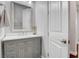 Chic powder room featuring a gray vanity with a white countertop and stylish fixtures at , Las Vegas, NV 89138