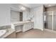 Bright bathroom featuring a large vanity, soaking tub, and a glass-enclosed shower at , Las Vegas, NV 89138
