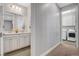 Bathroom with double vanity leading to hallway and laundry room with washer and dryer at , Las Vegas, NV 89138