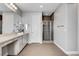 Bright primary bathroom featuring a long vanity and a glass-enclosed shower with tile accents at , Las Vegas, NV 89138