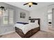Relaxing bedroom with a view to the laundry room offering carpet flooring, a ceiling fan, and whitewashed accent wall at , Las Vegas, NV 89138