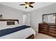 Serene bedroom featuring a dark wooden dresser, soft carpet, and a ceiling fan for a comfortable atmosphere at , Las Vegas, NV 89138