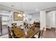 Stylish dining room featuring a wooden table set for six, chandelier lighting, and hardwood floors at , Las Vegas, NV 89138