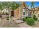Inviting front entrance with desert landscaping, a paved walkway, and a charming porch at , Las Vegas, NV 89138