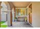 Cozy front porch with brick flooring, decorative pillars, and a comfortable bench at , Las Vegas, NV 89138