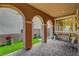 Charming front porch features classic archways, verdant turf, and cozy seating area at , Las Vegas, NV 89138