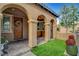 Inviting front porch with classic columns, brick flooring, and manicured greenery at , Las Vegas, NV 89138