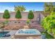 Inviting hot tub with a basketball hoop adjacent to the swimming pool and meticulously manicured landscaping at , Las Vegas, NV 89138