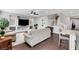Comfortable open-plan living area with built-in shelving, staircase access, and wood-look flooring at , Las Vegas, NV 89138