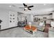 Open living area with hardwood floors, a cozy sofa, and view of the staircase and kitchen at , Las Vegas, NV 89138