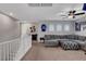 Inviting loft area with plush seating, ceiling fan, and arched windows creating a welcoming atmosphere at , Las Vegas, NV 89138