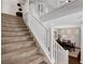 Carpeted staircase with white railing leads to the second floor, offering a glimpse of the dining area below at , Las Vegas, NV 89138