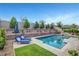 A serene outdoor space with a swimming pool, sun loungers, and lush landscaping for ultimate relaxation and enjoyment at , Las Vegas, NV 89138