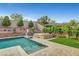 A serene backyard featuring a beautiful pool, hot tub, and lush landscaping, perfect for relaxation at , Las Vegas, NV 89138