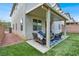 Charming backyard patio with cozy seating area and artificial grass at 10426 Mount Washington Ave, Las Vegas, NV 89166