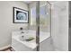 Bathroom featuring a bathtub with glass shower doors and a decorative picture on the wall at 10426 Mount Washington Ave, Las Vegas, NV 89166